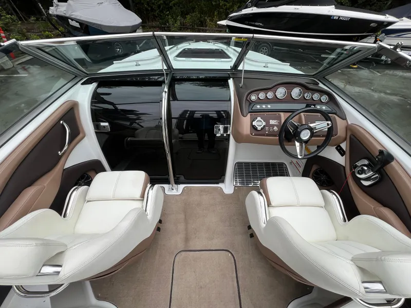 Slide: The Image of Interior of a 2014 Cobalt 243 boat with steering console. - 13