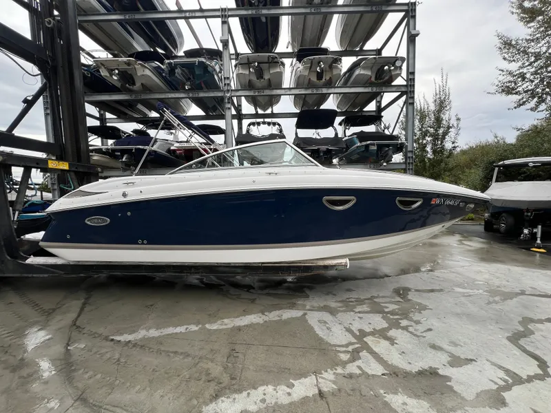 Slide: The Image of 2014 Cobalt 243 boat on an outdoor boat rack. - 6