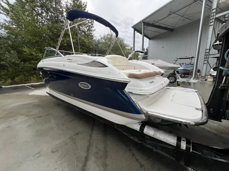 Slide: The Image of 2014 Cobalt 243 boat on a trailer outdoors. - 8