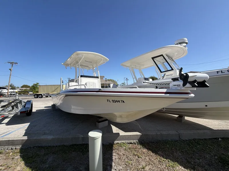 Slide: The Image of 2023 Ranger 2510 boat parked outdoors under clear blue sky. - 10