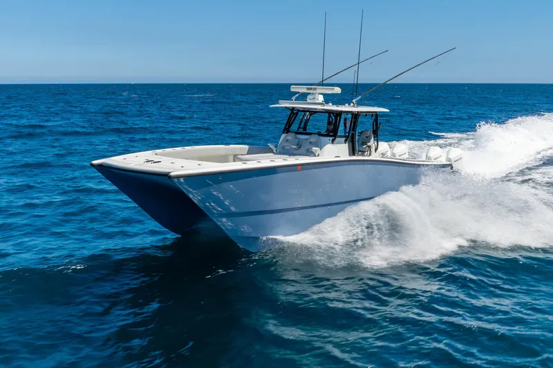 Slide: The Image of 2019 Freeman 42LR boat cruising on open ocean under clear blue sky. - 1