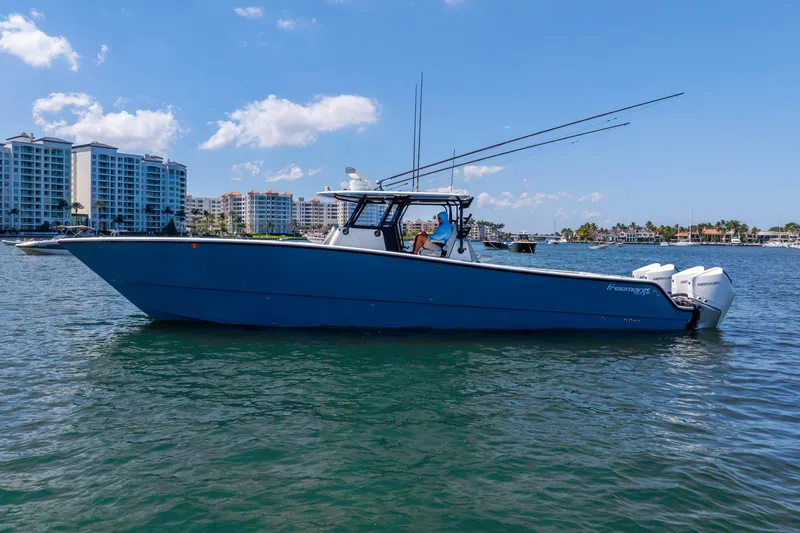 Slide: The Image of 2019 Freeman 42LR boat on water with cityscape background, clear sky. - 10