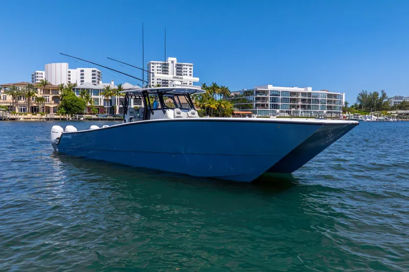 Slide: The Image of 2019 Freeman 42LR boat on water, with modern buildings in the background. - 12