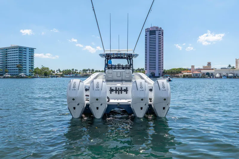 Slide: The Image of 2019 Freeman 42LR boat with four engines on water, cityscape background. - 14