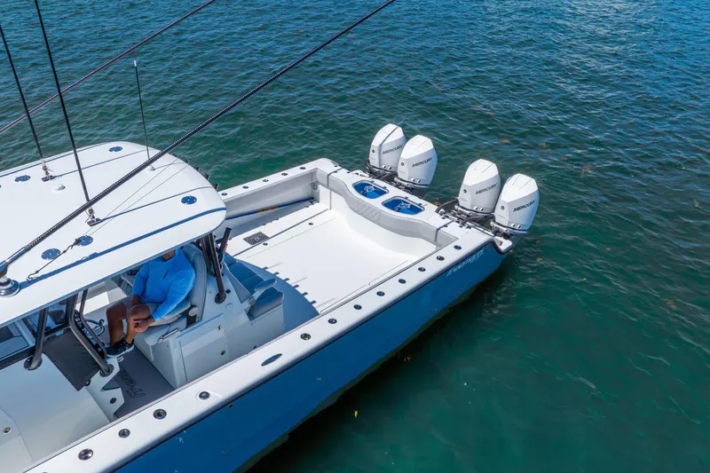 Slide: The Image of Aerial view of 2019 Freeman 42LR boat with four Mercury engines on the water. - 16