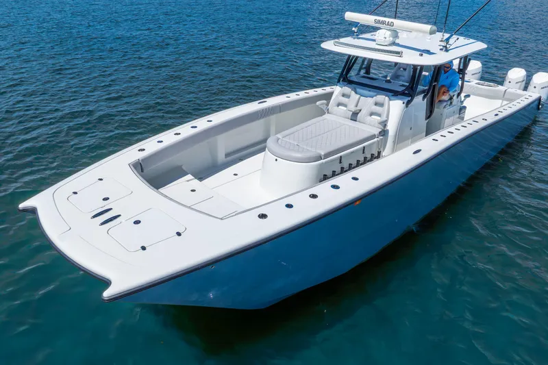 Slide: The Image of 2019 Freeman 42LR boat on clear blue water, showcasing sleek design and spacious deck. - 17