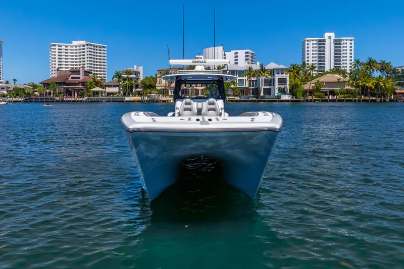 Slide: The Image of Front view of a 2019 Freeman 42LR boat on water, with cityscape background. - 18