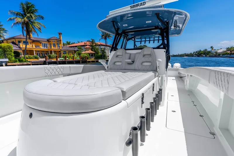 Slide: The Image of Luxurious 2019 Freeman 42LR boat with plush seating, docked near waterfront homes. - 26