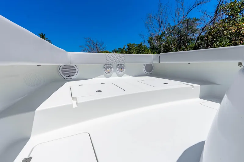 Slide: The Image of 2019 Freeman 42LR boat interior with white seating and storage compartments under clear blue sky. - 28