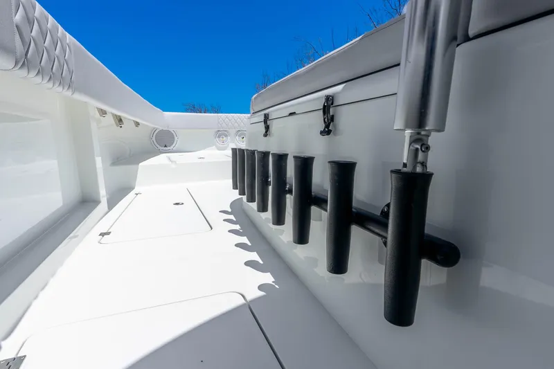 Slide: The Image of 2019 Freeman 42LR boat deck with rod holders under clear blue sky. - 30