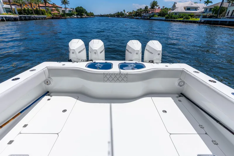 Slide: The Image of Sleek 2019 Freeman 42LR boat with four Mercury engines on a scenic waterway. - 33