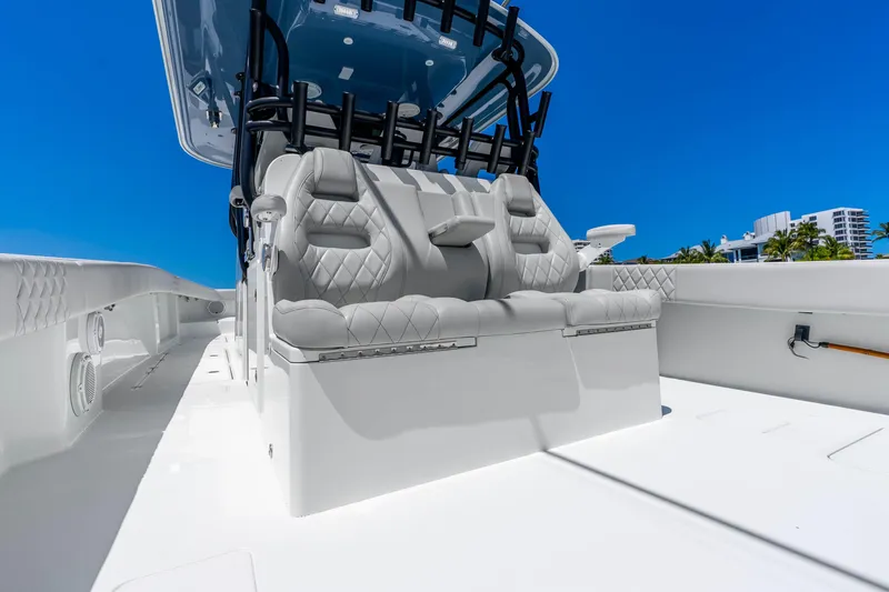 Slide: The Image of Luxurious seating on a 2019 Freeman 42LR boat under a clear blue sky. - 36