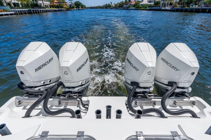 Slide: The Image of 2019 Freeman 42LR boat with four Mercury outboard engines on a scenic waterway. - 38