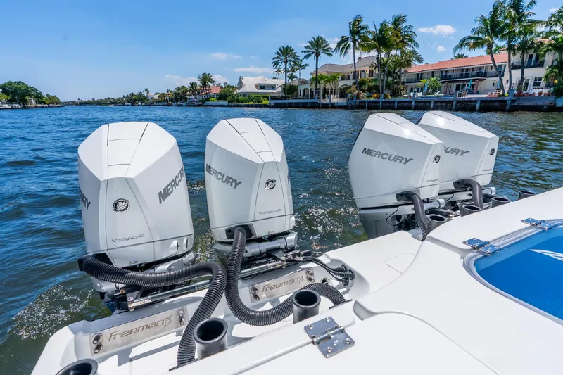 Slide: The Image of 2019 Freeman 42LR boat with four Mercury Verado engines on a sunny waterfront. - 39