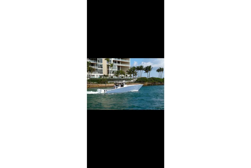 Slide: The Image of 2019 Freeman 42LR boat cruising on open blue ocean waters. - 4