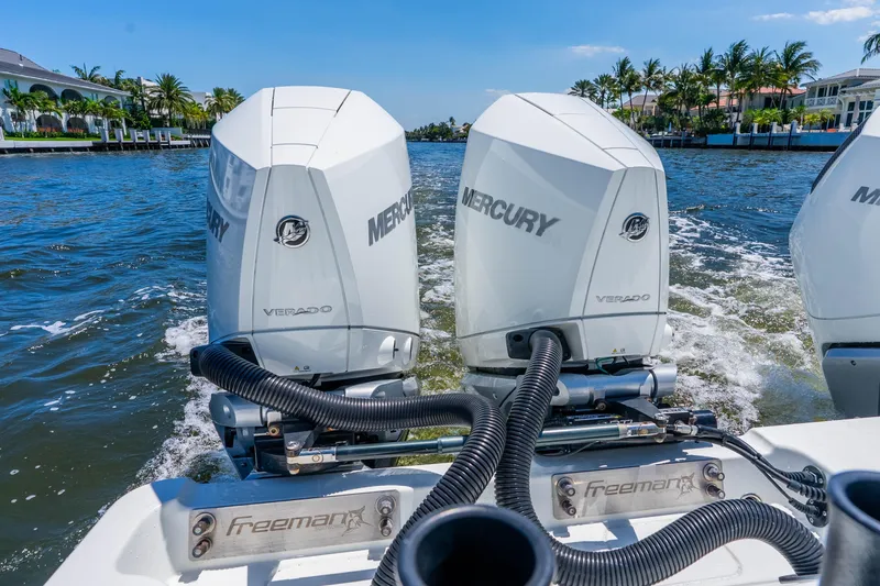 Slide: The Image of Freeman 42LR 2019 boat with dual Mercury Verado engines cruising on a sunny waterway. - 40