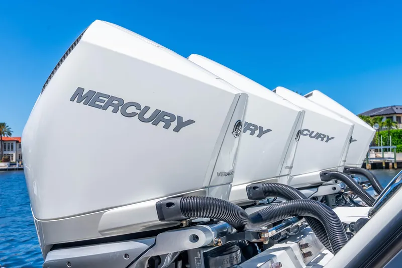 Slide: The Image of Triple Mercury Verado outboard engines on a 2019 Freeman 42LR boat, docked by the water. - 44