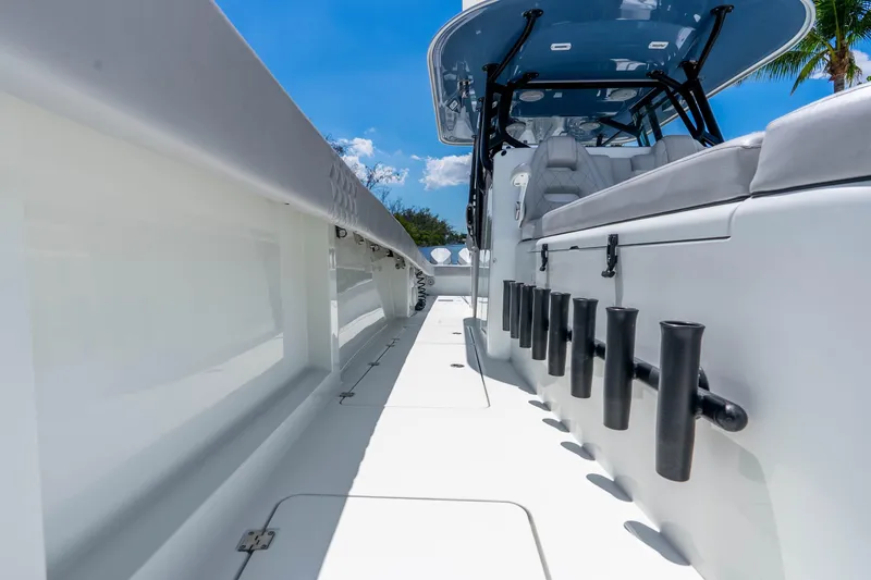 Slide: The Image of 2019 Freeman 42LR boat deck with rod holders under clear blue sky. - 45
