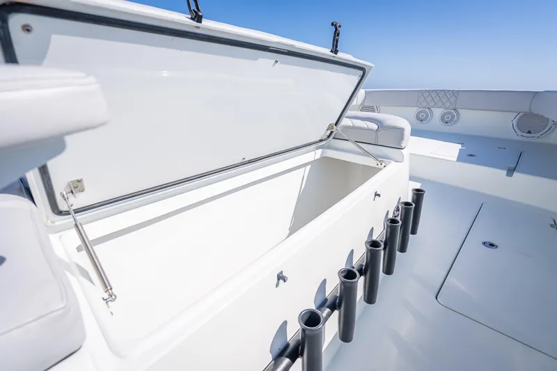 Slide: The Image of Open storage compartment on 2019 Freeman 42LR boat deck with rod holders. - 46