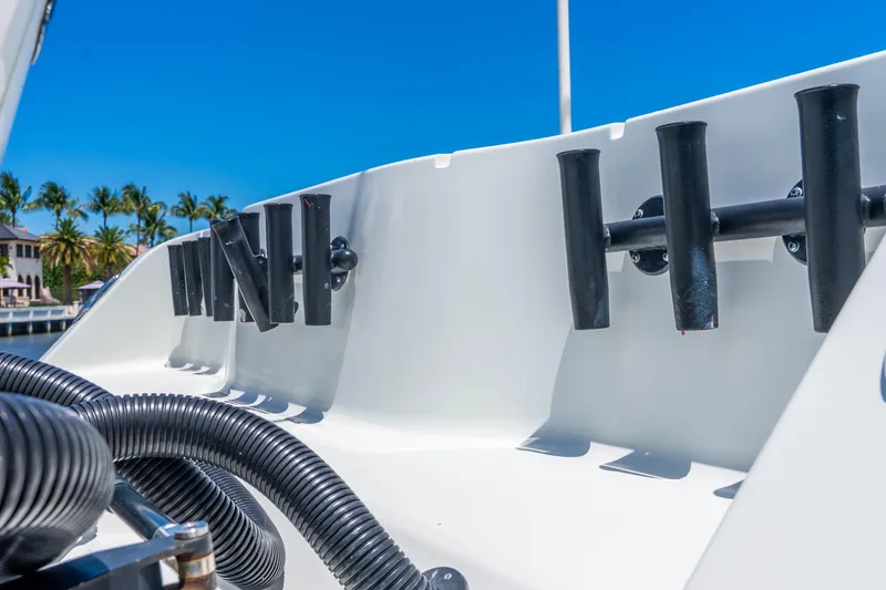 Slide: The Image of Freeman 42LR 2019 boat with rod holders and hoses, docked under clear blue sky. - 47
