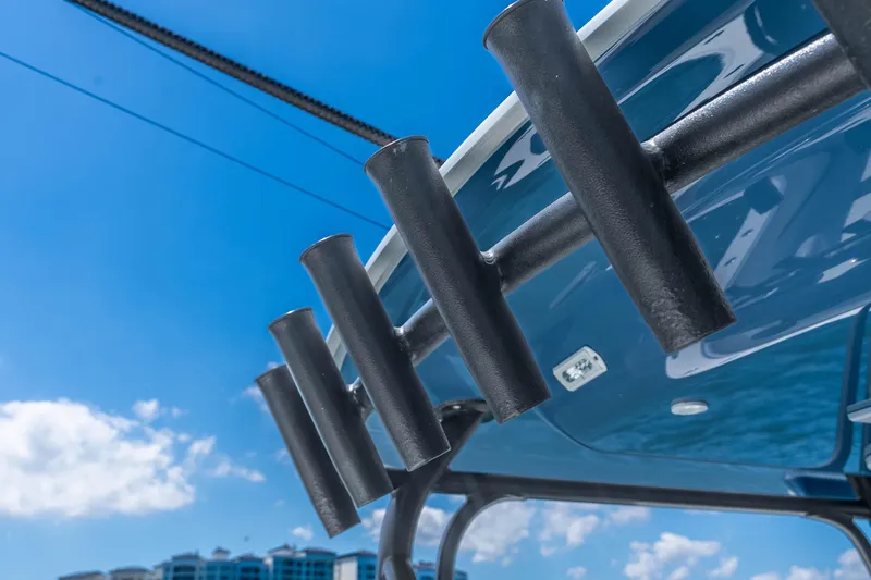 Slide: The Image of Rod holders on a 2019 Freeman 42LR boat under a clear blue sky. - 48
