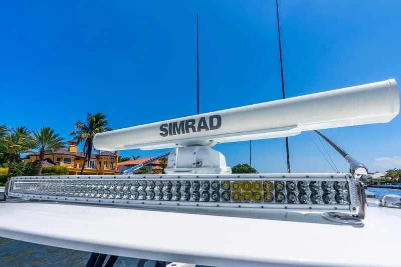 Slide: The Image of Radar and LED light bar on a 2019 Freeman 42LR boat under clear blue sky. - 49