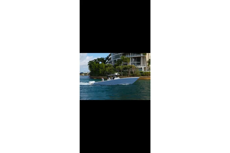 Slide: The Image of 2019 Freeman 42LR boat cruising on open ocean under clear blue sky. - 5