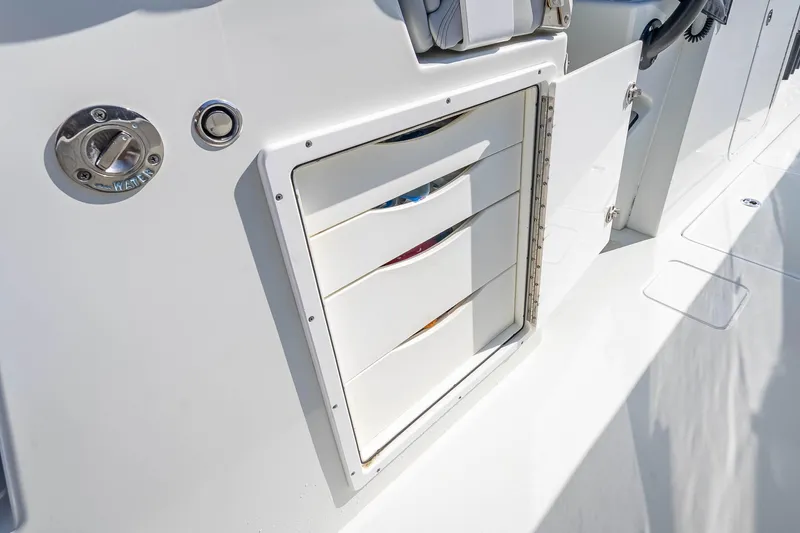 Slide: The Image of Storage compartment on a 2019 Freeman 42LR boat, featuring sleek white drawers. - 52