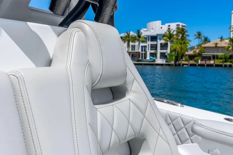 Slide: The Image of Luxurious white leather seating on a 2019 Freeman 42LR boat, with waterfront view. - 53