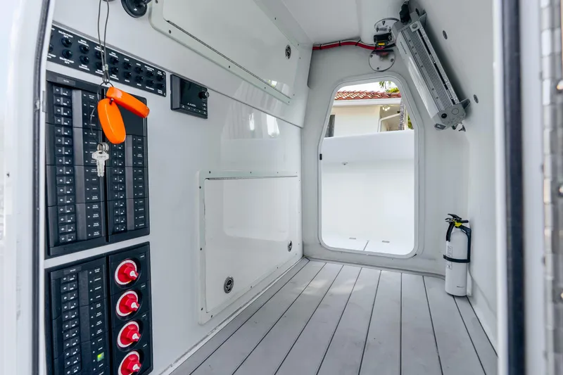 Slide: The Image of Interior of a 2019 Freeman 42LR boat showing control panels and safety equipment. - 54