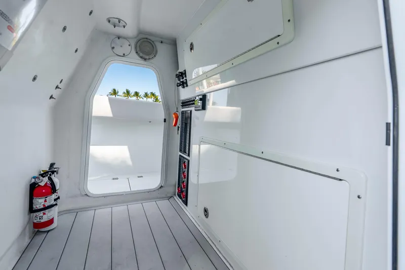 Slide: The Image of Interior of a 2019 Freeman 42LR boat, featuring storage compartments and a fire extinguisher. - 55