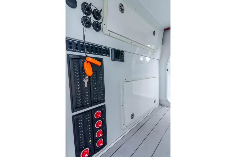 Slide: The Image of Control panel inside a 2019 Freeman 42LR boat, featuring switches and storage compartments. - 57