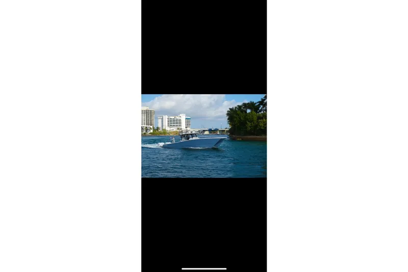 Slide: The Image of Aerial view of 2019 Freeman 42LR boat on clear blue water. - 7