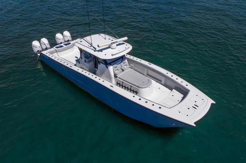Slide: The Image of 2019 Freeman 42LR boat with triple engines on clear blue water. - 8