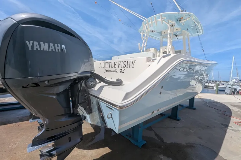 Slide: The Image of 2023 Cobia 301 Center Console boat with Yamaha engine, docked in Jacksonville, FL. - 32