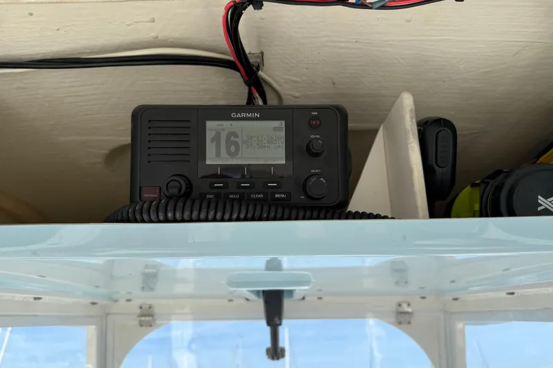 Slide: The Image of Garmin radio installed on 2023 Cobia 301 Center Console boat dashboard. - 34