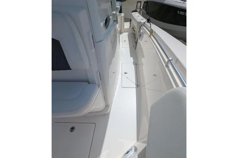 Slide: The Image of 2023 Cobia 301 Center Console boat interior with sleek seating and storage compartments. - 37