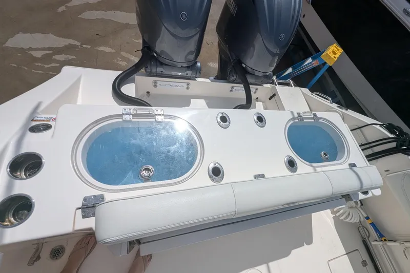 Slide: The Image of 2023 Cobia 301 Center Console boat with dual Yamaha engines and livewell. - 40