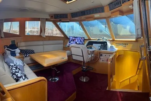 Slide: The Image of Interior of 1999 McKinna 57 Pilothouse yacht with plush seating and navigation area. - 10