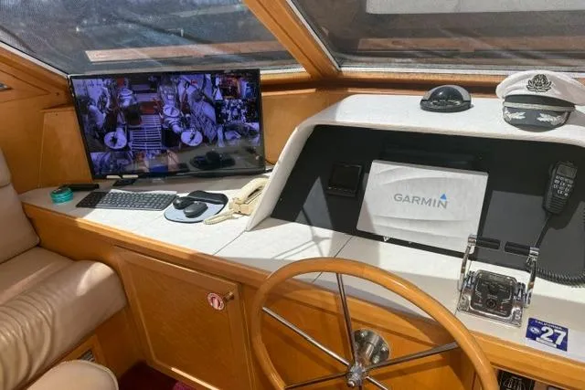 Slide: The Image of Interior of 1999 McKinna 57 Pilothouse with helm and Garmin system. - 12