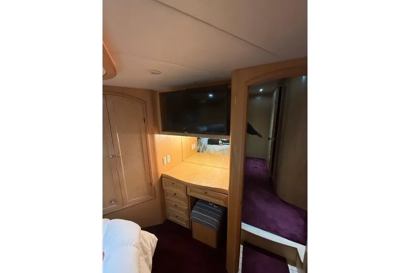 Slide: The Image of Interior of 1999 McKinna 57 Pilothouse with desk, TV, and wooden cabinetry. - 22