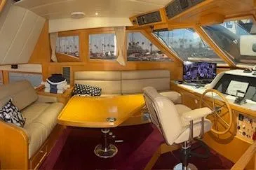 Slide: The Image of Luxurious 1999 McKinna 57 Pilothouse interior with plush seating and modern navigation equipment. - 24