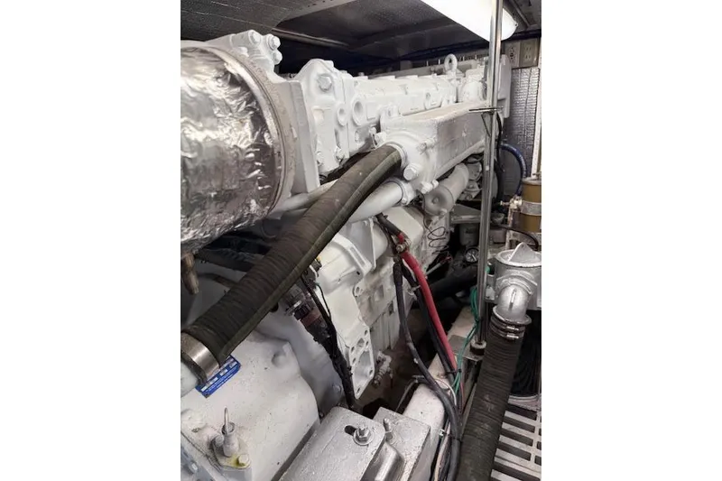 Slide: The Image of Engine room of a 1999 McKinna 57 Pilothouse yacht, showcasing detailed machinery. - 26