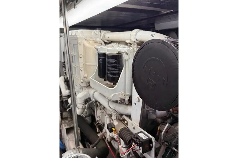 Slide: The Image of Engine compartment of a 1999 McKinna 57 Pilothouse yacht, showcasing mechanical components. - 28