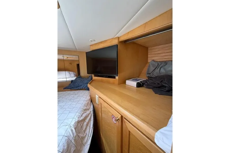 Slide: The Image of Interior of 1999 McKinna 57 Pilothouse with TV and wooden cabinetry. - 30