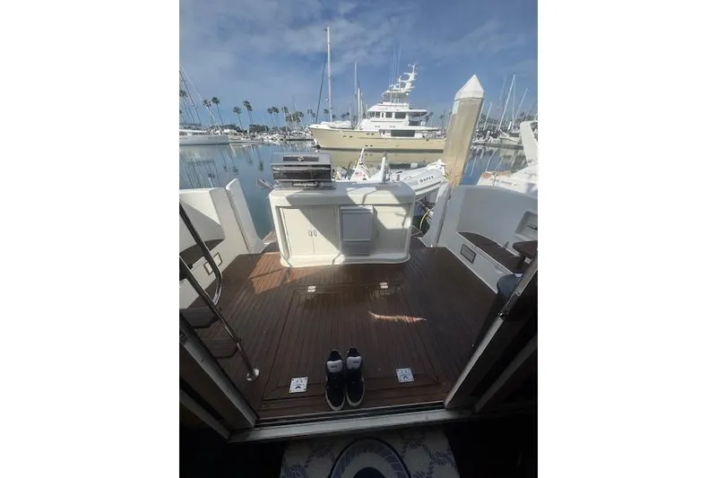 Slide: The Image of 1999 McKinna 57 Pilothouse yacht deck with marina view and clear skies. - 7