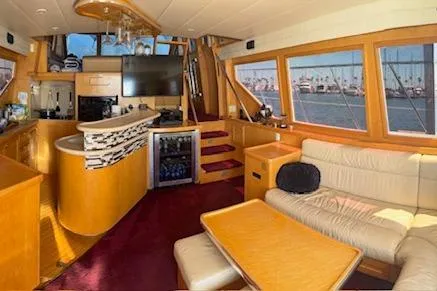 Slide: The Image of Luxurious interior of a 1999 McKinna 57 Pilothouse yacht with elegant seating and panoramic windows. - 8