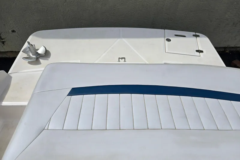 Slide: The Image of 2008 Regal 1900 Bowrider boat interior with white and blue seating, featuring a decorative anchor. - 11