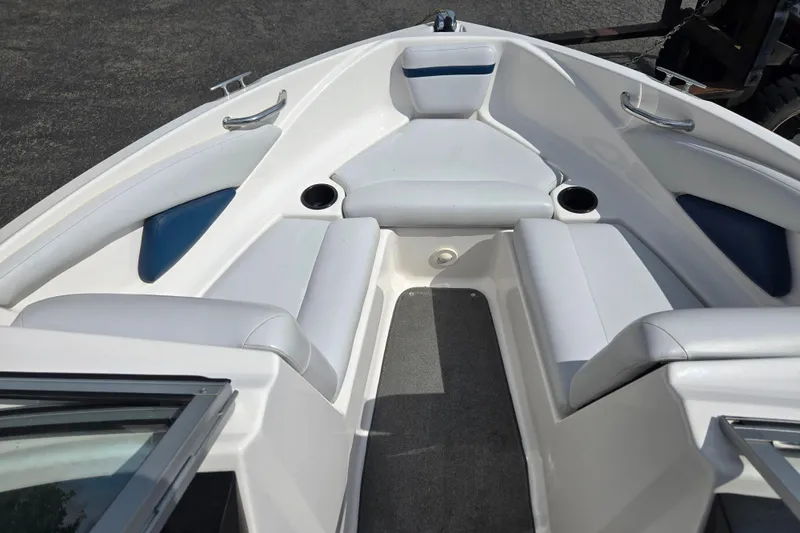 Slide: The Image of 2008 Regal 1900 Bowrider interior with white seating and cup holders. - 12