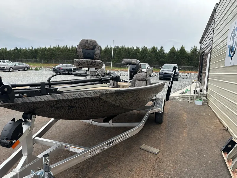 Slide: The Image of 2026 Xpress H17 boat on trailer beside building. - 3